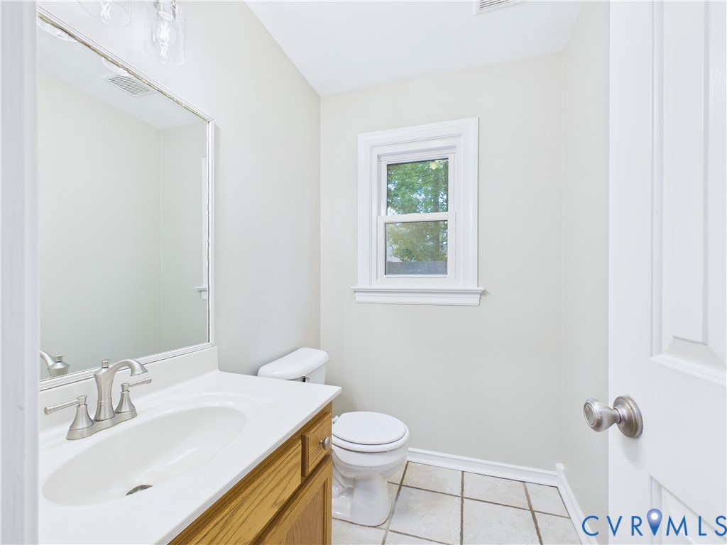 4502 Greyfield Place Chester, VA 23831 - Photo 29 of 40 a bathroom with a sink a toilet and mirror