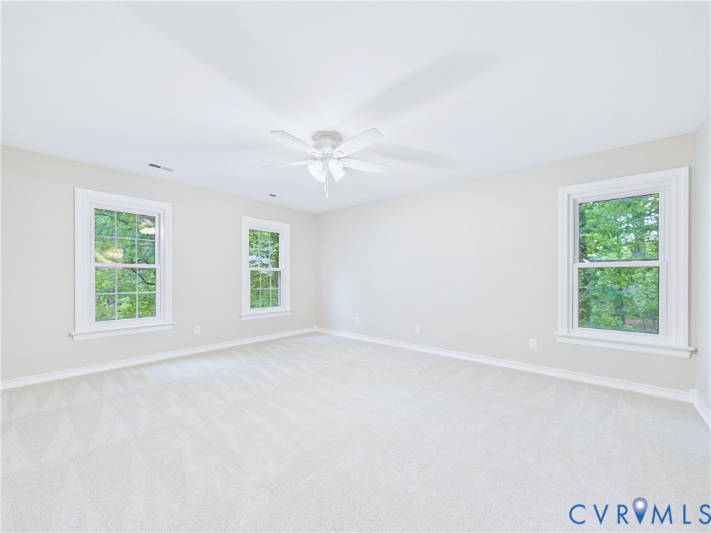 4502 Greyfield Place Chester, VA 23831 - Photo 30 of 40 an empty room with windows and fan