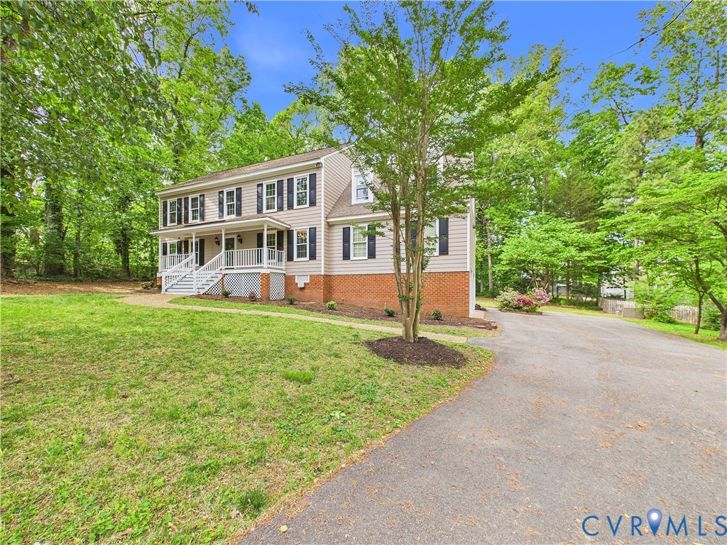 4502 Greyfield Place Chester, VA 23831 - Photo 3 of 40 a front view of a house with a yard and trees