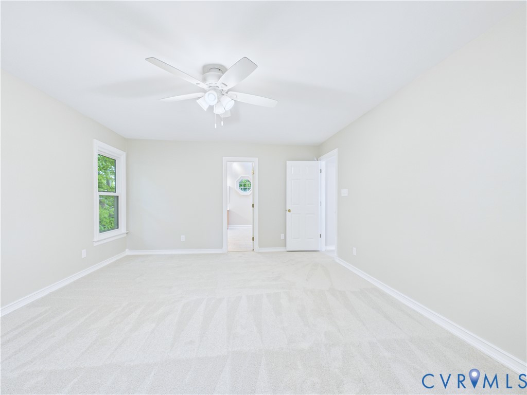 4502 Greyfield Place Chester, VA 23831 - Photo 31 of 40 an empty room with windows and fan
