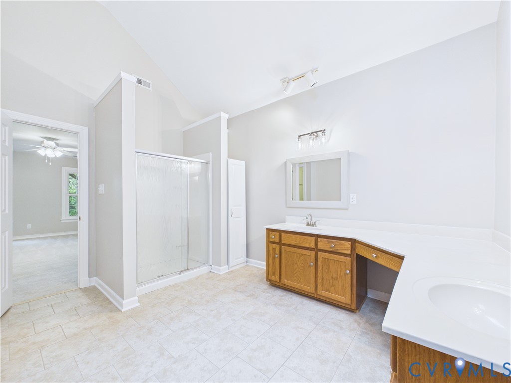 4502 Greyfield Place Chester, VA 23831 - Photo 34 of 40 a bathroom with a tub sink and mirror