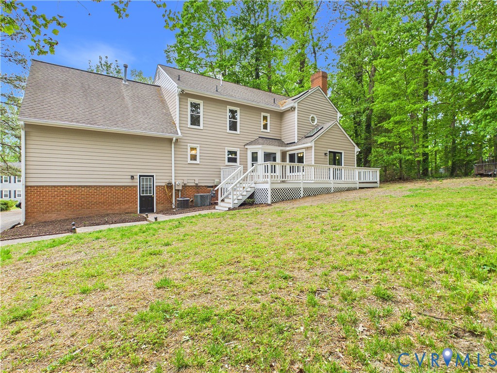 4502 Greyfield Place Chester, VA 23831 - Photo 4 of 40 a front view of a house with a garden and plants