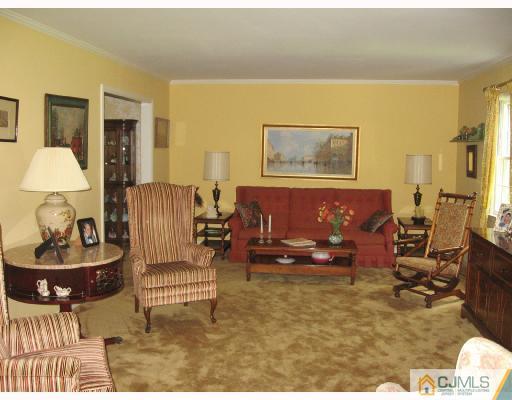 116 George Avenue Edison, NJ 08820 - Photo 2 of 8 a living room with furniture and a lamp