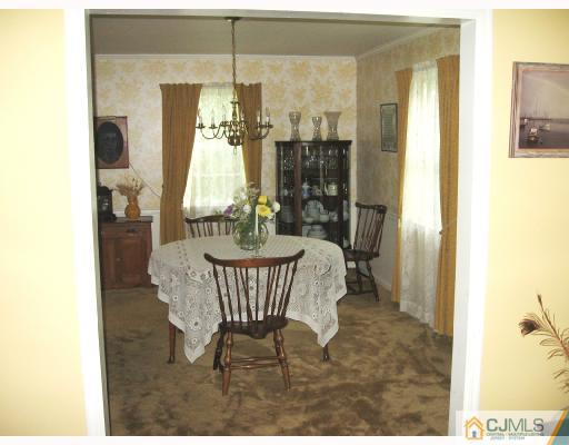 116 George Avenue Edison, NJ 08820 - Photo 3 of 8 a view of a dining room with furniture and a window