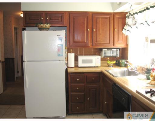 116 George Avenue Edison, NJ 08820 - Photo 4 of 8 a kitchen with stainless steel appliances granite countertop a refrigerator a sink and dishwasher