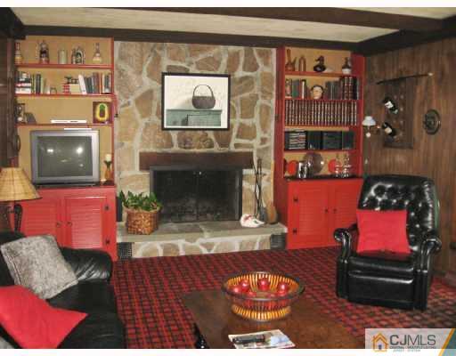 116 George Avenue Edison, NJ 08820 - Photo 5 of 8 a living room with furniture and a fireplace