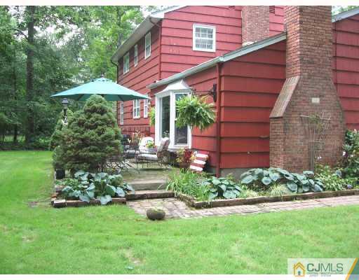 116 George Avenue Edison, NJ 08820 - Photo 8 of 8 a view of a yard with a table and chair under an umbrella