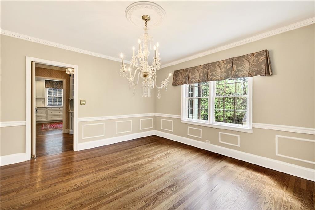596 West Wesley Road Northwest Atlanta, GA 30305 - Photo 12 of 60 a view of an empty room with wooden floor and a window