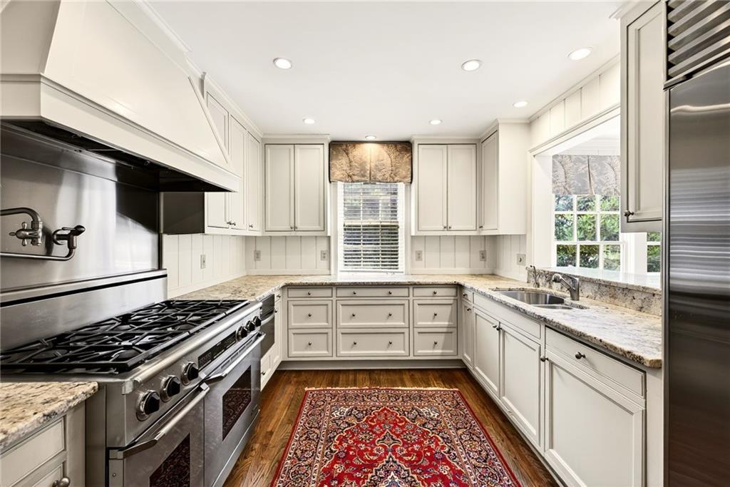 596 West Wesley Road Northwest Atlanta, GA 30305 - Photo 16 of 60 a kitchen that has a sink and a stove