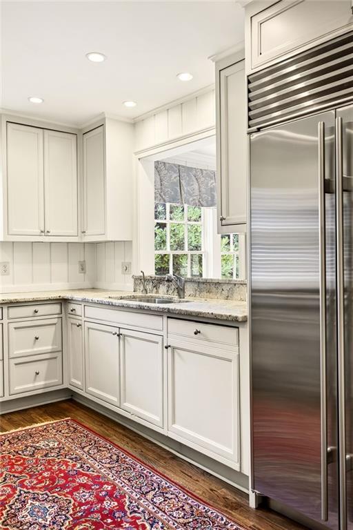 596 West Wesley Road Northwest Atlanta, GA 30305 - Photo 18 of 60 a kitchen with granite countertop stainless steel appliances a sink and cabinets