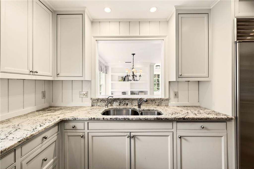 596 West Wesley Road Northwest Atlanta, GA 30305 - Photo 19 of 60 a kitchen with stainless steel appliances granite countertop a sink and a white cabinets