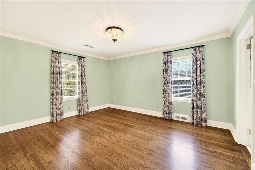596 West Wesley Road Northwest Atlanta, GA 30305 - Photo 28 of 60 an empty room with wooden floor and windows