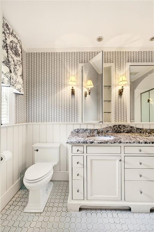 596 West Wesley Road Northwest Atlanta, GA 30305 - Photo 32 of 60 a bathroom with a granite countertop toilet a sink a mirror and a shower