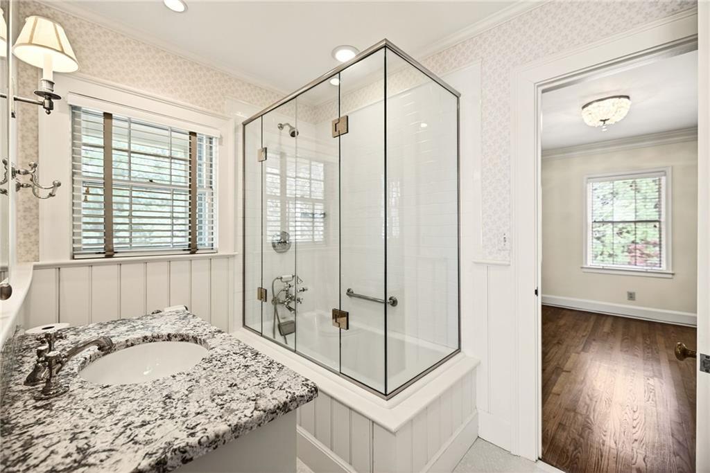 596 West Wesley Road Northwest Atlanta, GA 30305 - Photo 34 of 60 a view of a bathroom with a tub shower and window