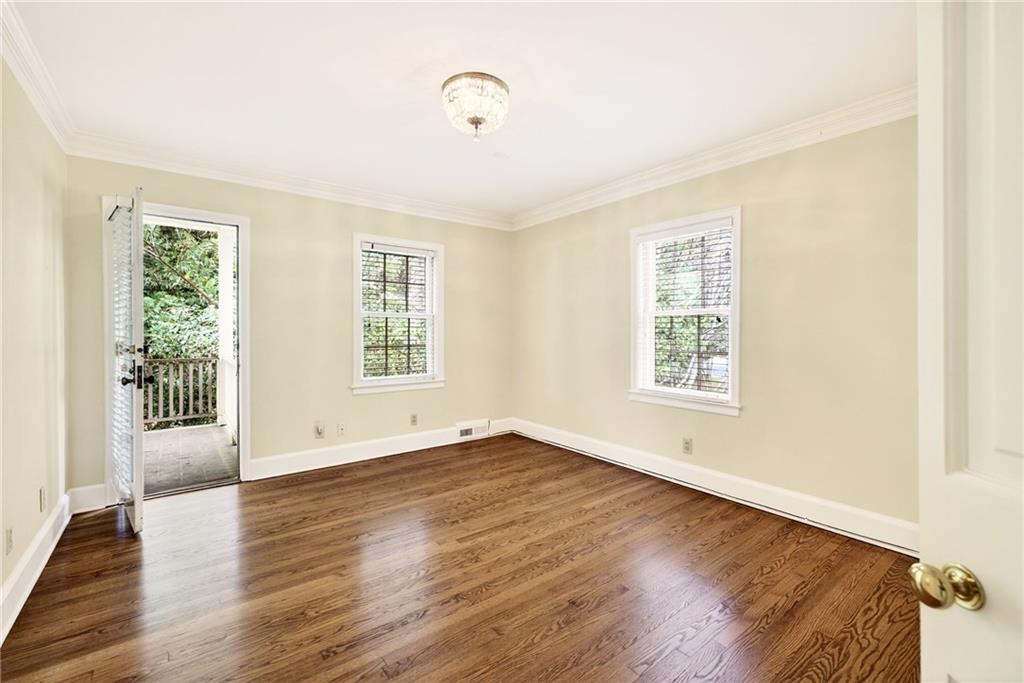 596 West Wesley Road Northwest Atlanta, GA 30305 - Photo 36 of 60 a view of an empty room with wooden floor and a window