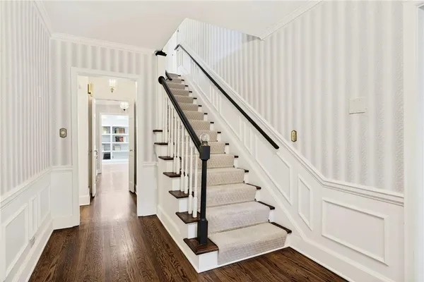 a view of entryway with wooden floor and stairs