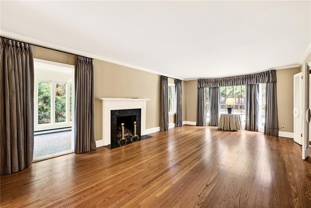 596 West Wesley Road Northwest Atlanta, GA 30305 - Photo 7 of 60 a view of an empty room with wooden floor and a window