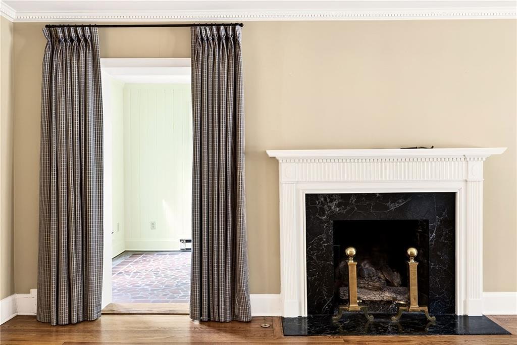 596 West Wesley Road Northwest Atlanta, GA 30305 - Photo 8 of 60 a view of a livingroom with wooden floor and a fireplace