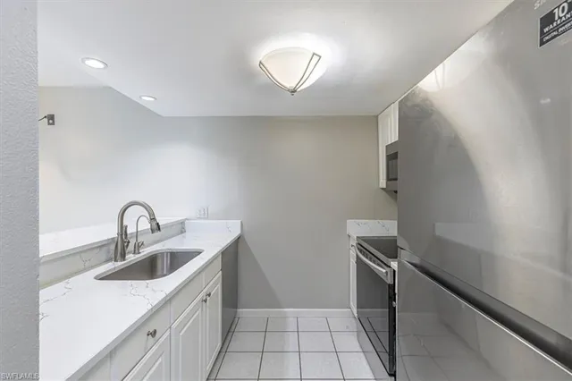 a kitchen with a sink and a stove top oven