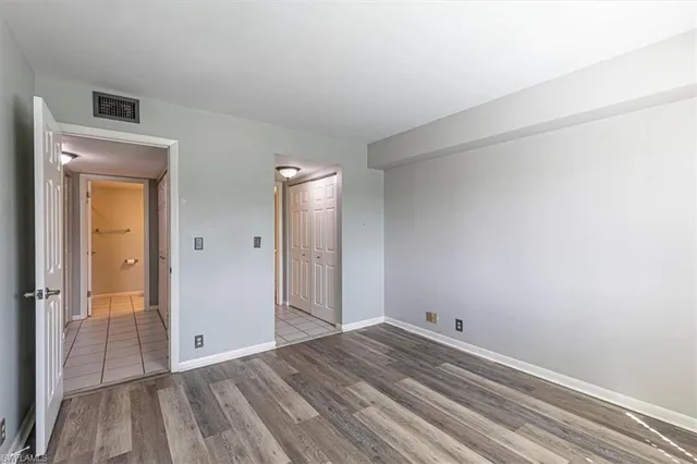 a view of a room with wooden floor