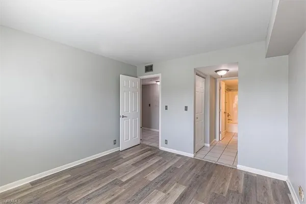 a view of an empty room and wooden floor