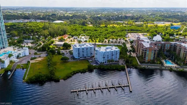 an aerial view of a house with a garden and lake view