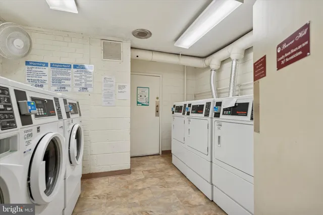 a view of a swimming pool with a bench and trees