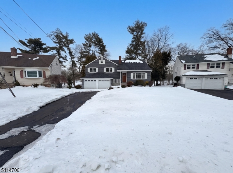 a view of a house with a snow in front of yard