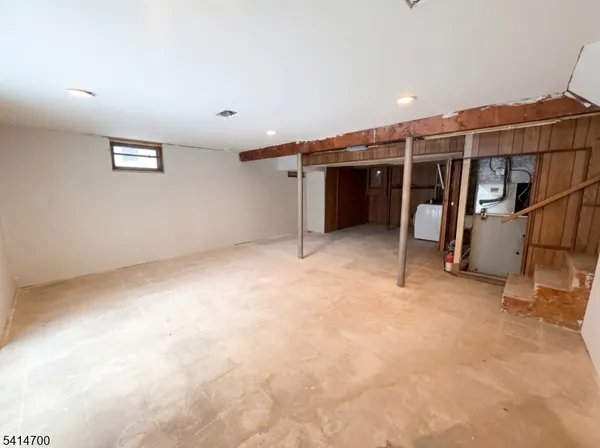 an empty room with furniture and window