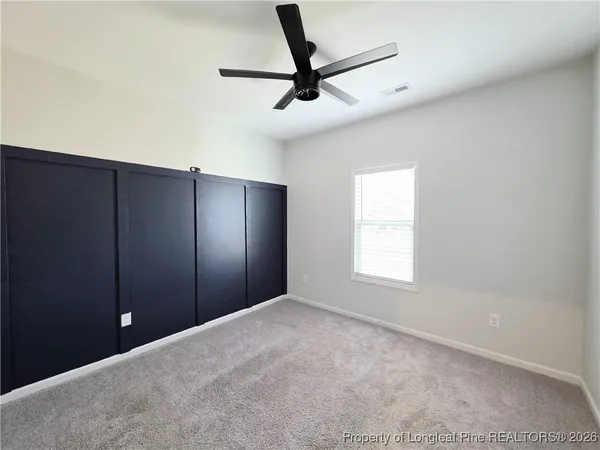 a view of a livingroom with a ceiling fan and window