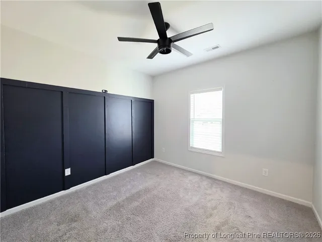 a view of a livingroom with a ceiling fan and window