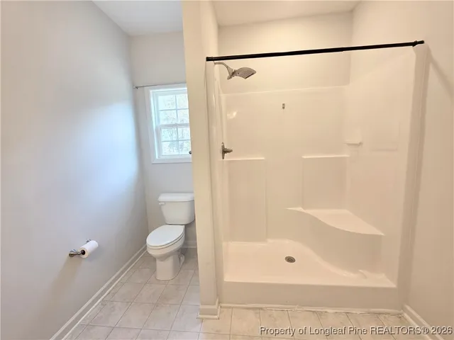 a bathroom with a shower and a toilet