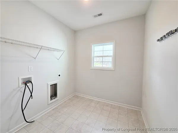 a view of a room with window and wooden floor