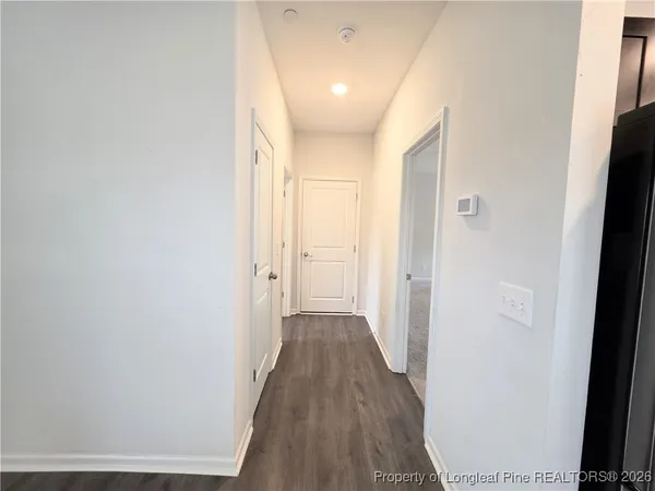 a view of a hallway with wooden floor