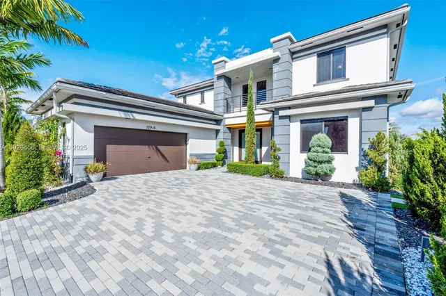 a front view of a house with a yard and a garage