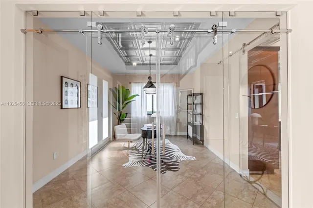 a view of an empty room with wooden floor and closet