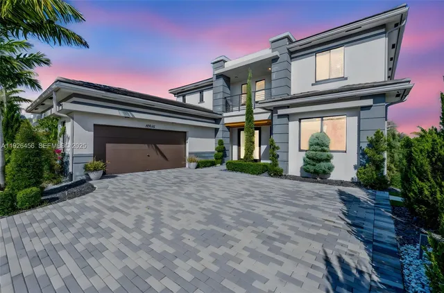 a front view of a house with a yard and garage