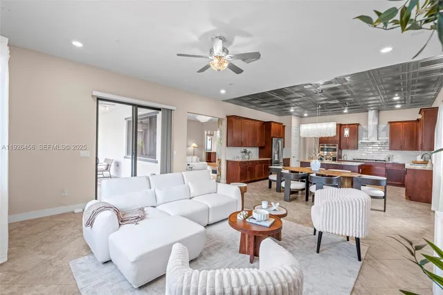 a living room with patio furniture and a floor to ceiling window