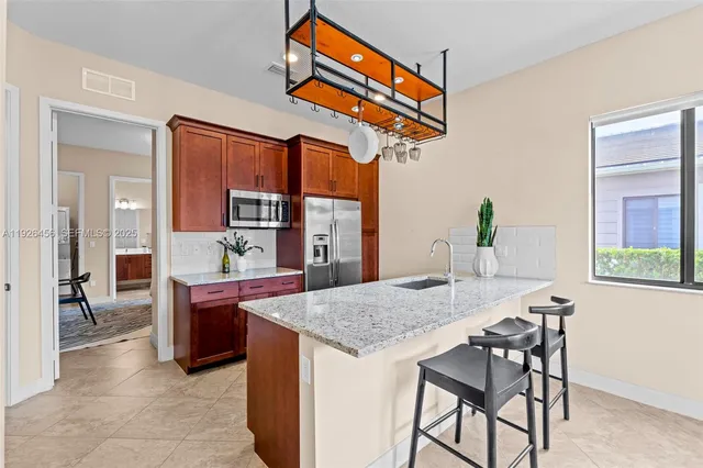 an aerial view of residential houses with outdoor space and parking