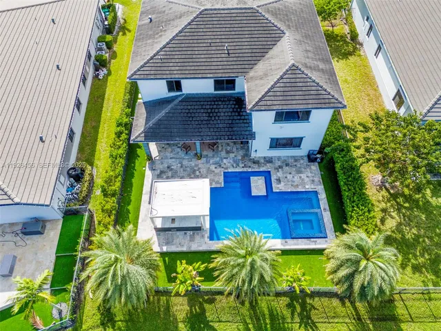 a front view of a house with garden and plants