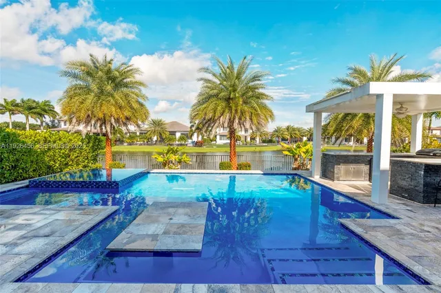 a kitchen with stainless steel appliances kitchen island a large counter space sink and stove