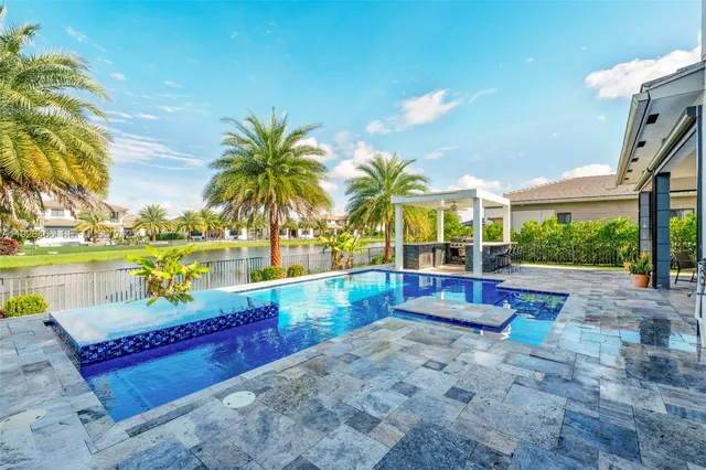 a living room with furniture a chandelier and a window