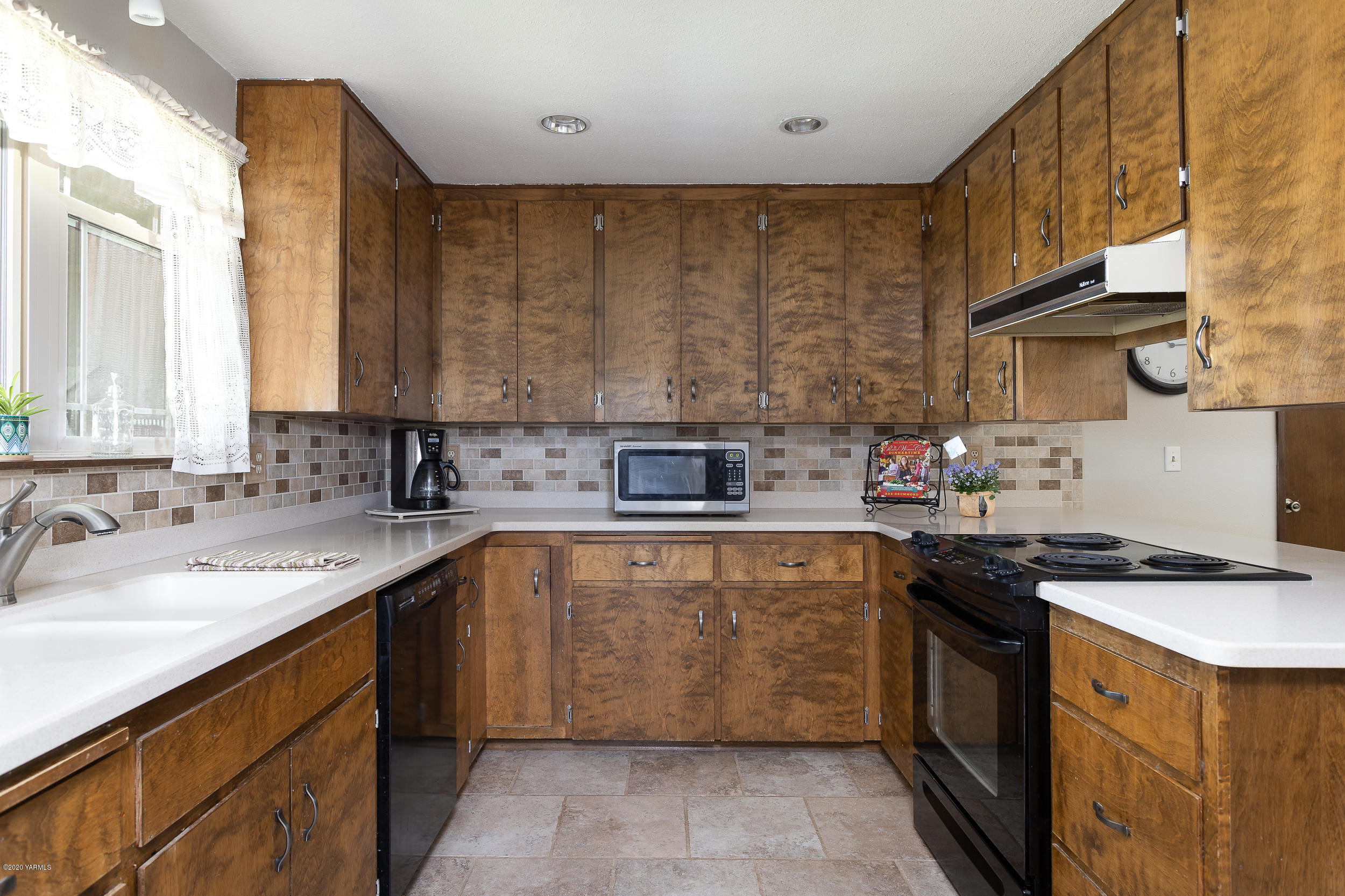 1020 Beane Road Moxee, WA 98936 - Photo 23 of 36 a kitchen with a sink stove and cabinets