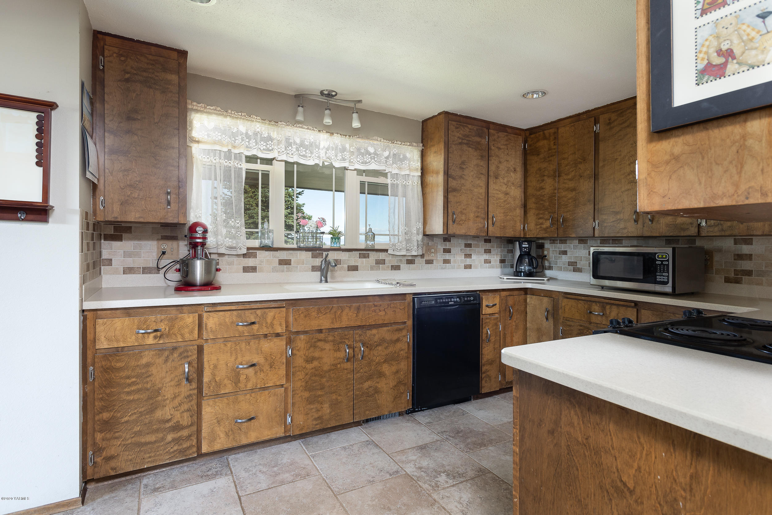 1020 Beane Road Moxee, WA 98936 - Photo 24 of 36 a kitchen with a sink stove and cabinets