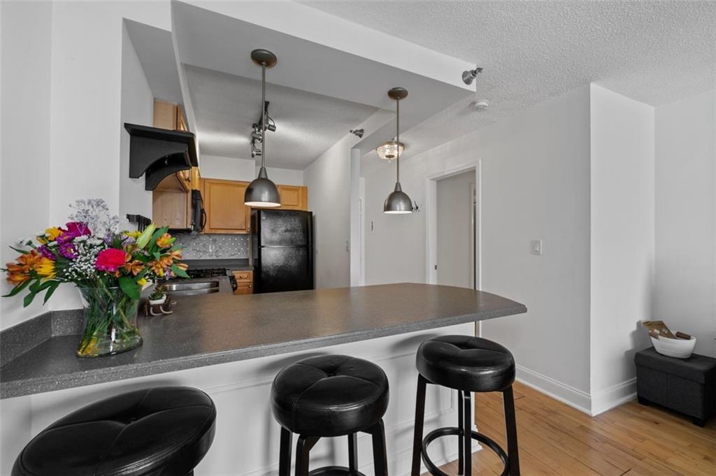 2479 Peachtree Street Northeast, Unit 912 Atlanta, GA 30305 - Photo 11 of 36 a dining room with furniture and wooden floor