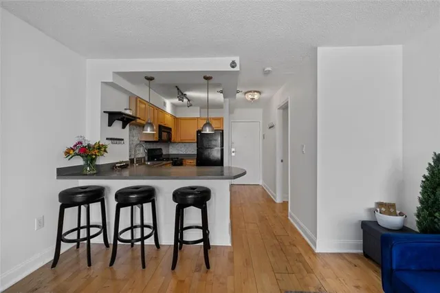 a dining room with furniture and wooden floor