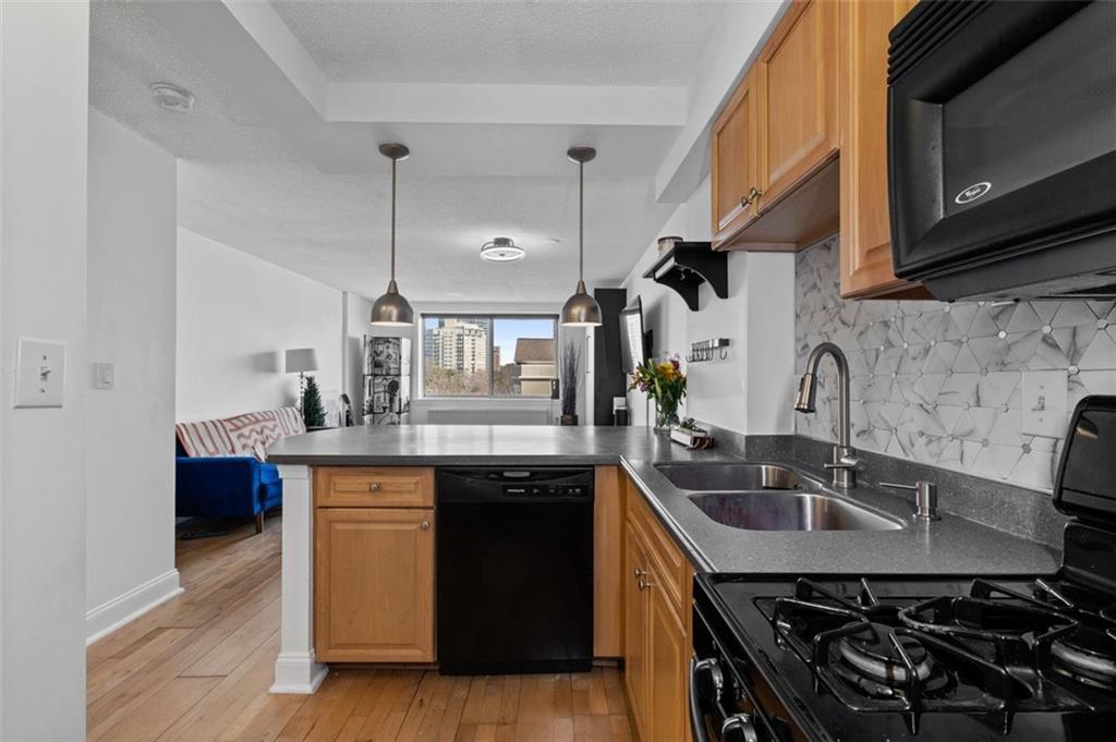 2479 Peachtree Street Northeast, Unit 912 Atlanta, GA 30305 - Photo 15 of 36 a kitchen with stainless steel appliances a sink stove and cabinets
