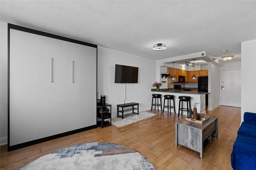 2479 Peachtree Street Northeast, Unit 912 Atlanta, GA 30305 - Photo 17 of 36 a living room with furniture and a flat screen tv
