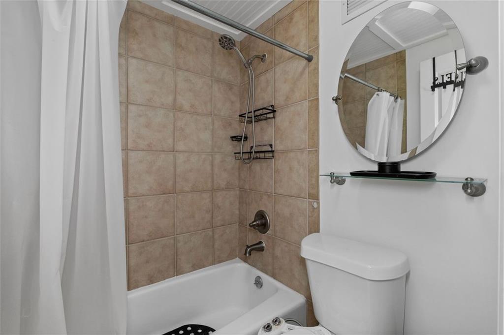 2479 Peachtree Street Northeast, Unit 912 Atlanta, GA 30305 - Photo 20 of 36 a bathroom with a toilet and a shower