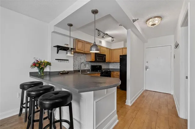 a kitchen that has a table and chairs in it